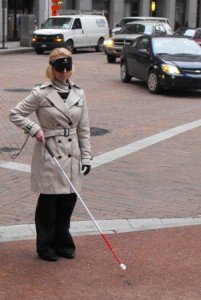 BVRS President Erika Arbogast navigates Downtown Pittsburgh streets under blindfold using a white cane