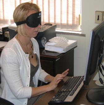 BVRS President Erika Arbogast, under blindford, learns screen reading software at her computer